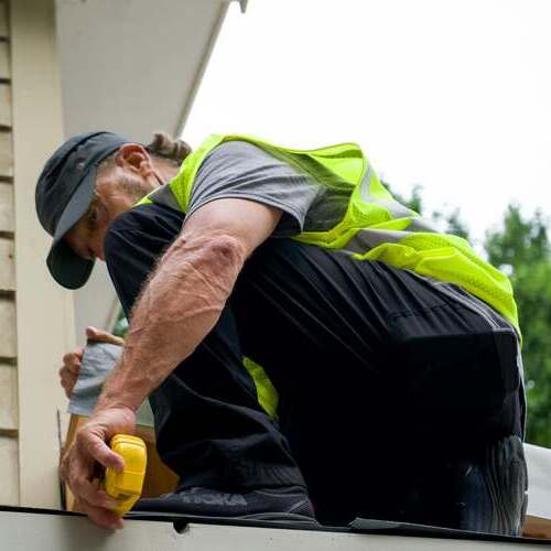 Roofer works on emergency roof repair.