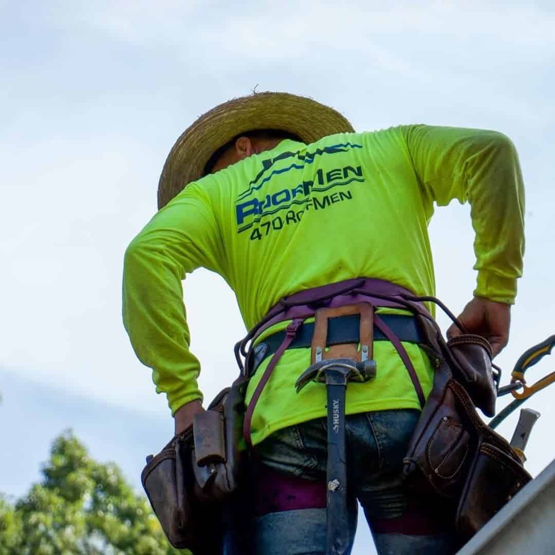 Roofer works on hail damage.