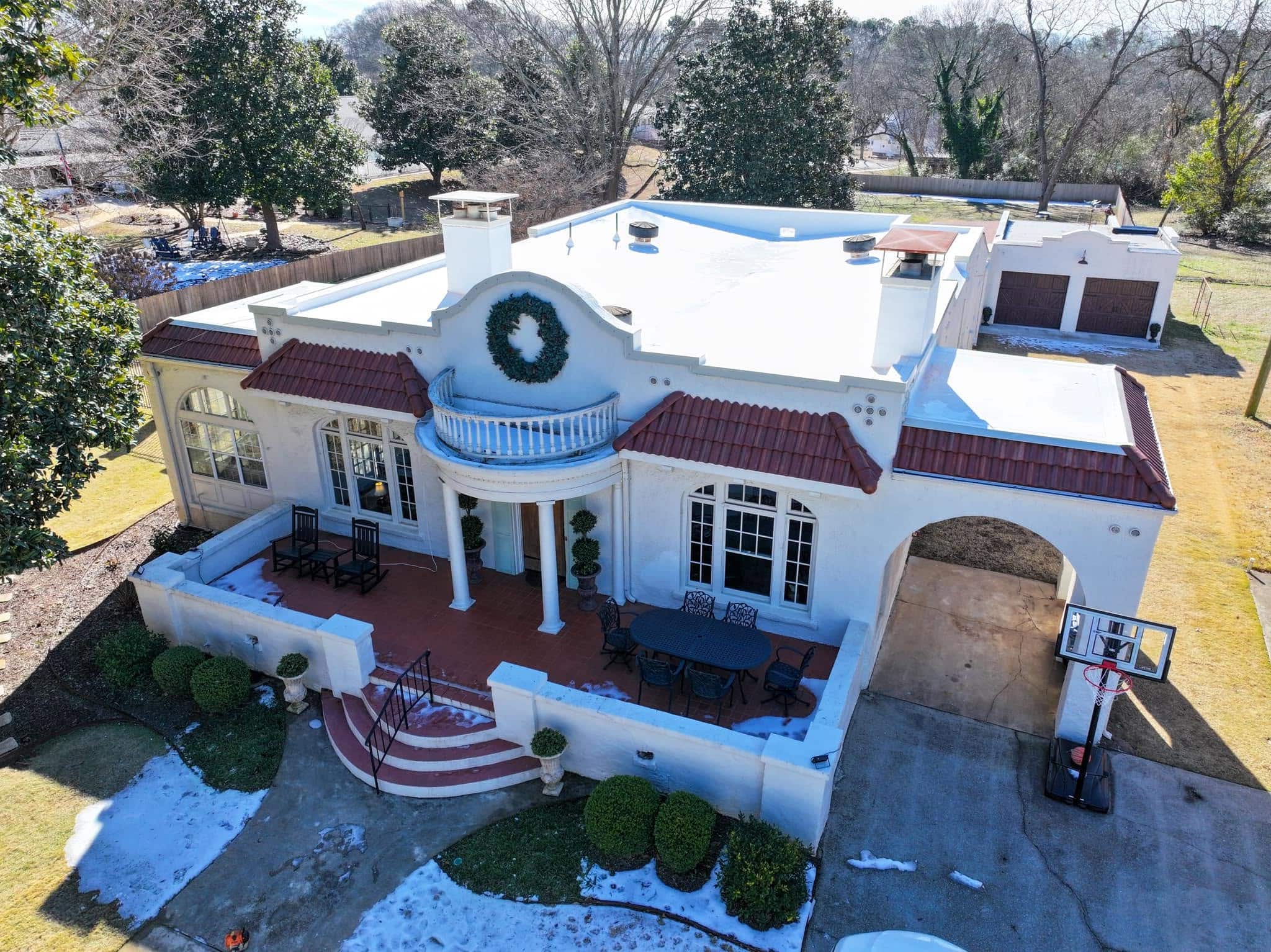 Home with tile and flat roofing